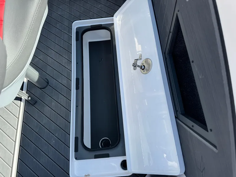Slide: The Image of Open storage compartment in 2025 Vexus DVX20S boat interior. - 31