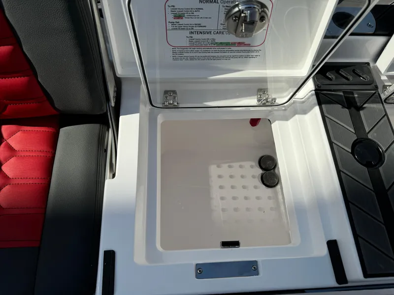Slide: The Image of 2025 Vexus DVX20S boat storage compartment with open lid and red seating. - 34