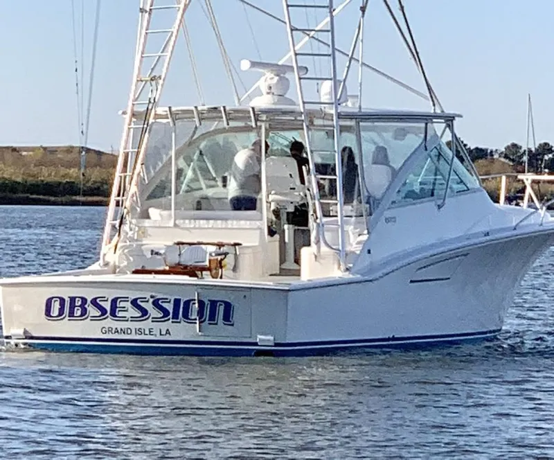Slide: The Image of 2004 Cabo 40 Express boat named "Obsession" on water, Grand Isle, LA. - 2