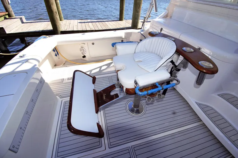 Slide: The Image of 2004 Cabo 40 Express boat cockpit with fishing chair and rod holders. - 4