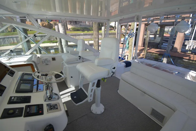 Slide: The Image of 2004 Cabo 40 Express yacht interior with helm, seating, and navigation equipment. - 6