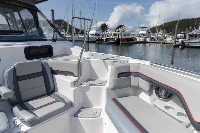 Slide: The Image of 2025 Solara S-310 CW boat interior with modern seating at a marina. - 34