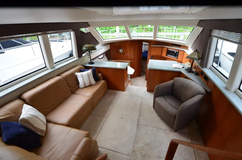 Slide: The Image of Interior of 2001 Carver 406 yacht with leather seating and modern amenities. - 11
