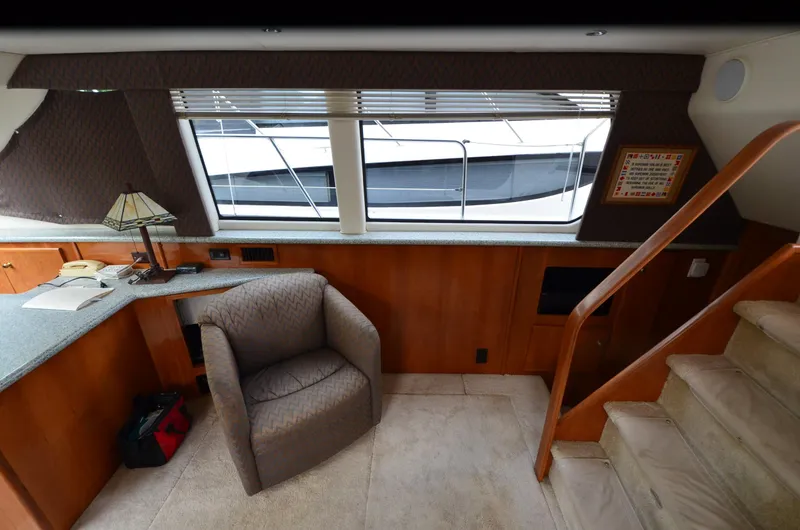 Slide: The Image of Interior of 2001 Carver 406 yacht with chair, stairs, and window view. - 12