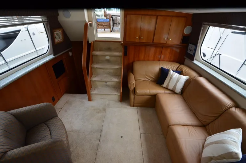 Slide: The Image of Interior of 2001 Carver 406 yacht with leather seating and wooden cabinetry. - 14