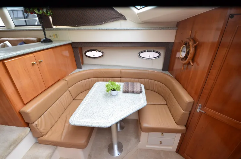 Slide: The Image of Luxurious interior of a 2001 Carver 406 yacht with a cozy dining area. - 16