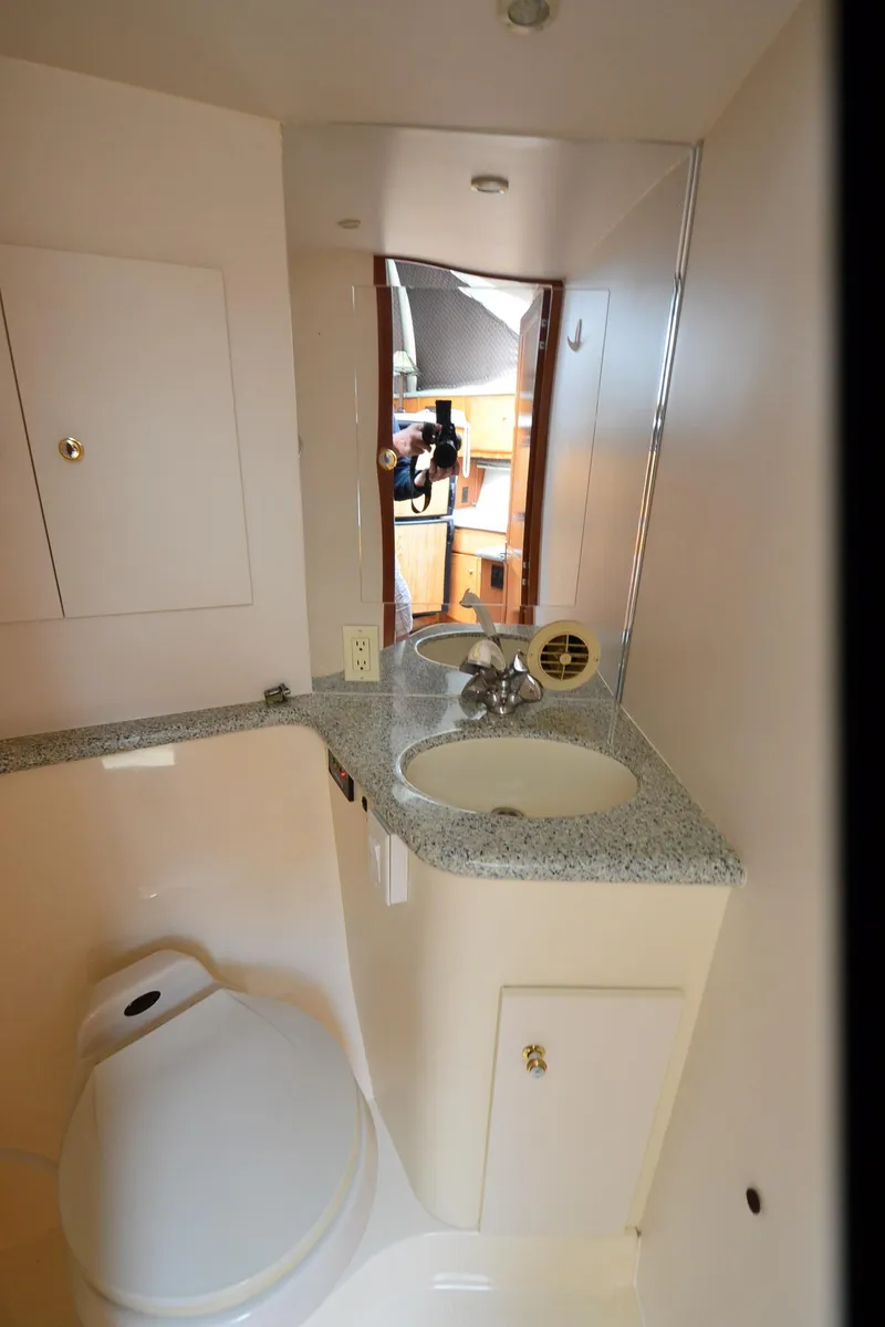 Slide: The Image of Bathroom interior of a 2001 Carver 406 yacht, featuring a sink and toilet. - 22