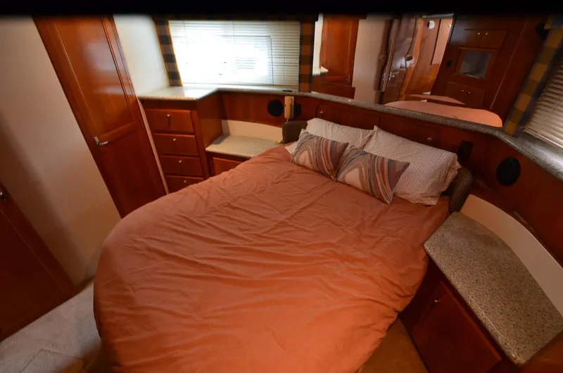 Slide: The Image of Interior of 2001 Carver 406 yacht bedroom with cozy bed and wooden cabinetry. - 27