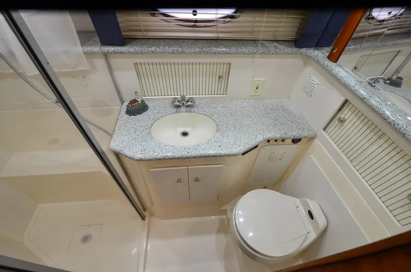 Slide: The Image of Bathroom interior of 2001 Carver 406 yacht with sink, toilet, and shower. - 28