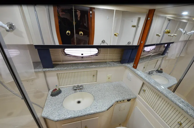 Slide: The Image of Bathroom interior of 2001 Carver 406 yacht with granite countertop and mirrored cabinets. - 29