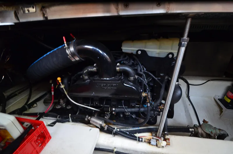 Slide: The Image of Engine compartment of a 2001 Carver 406 boat, showcasing mechanical components and hoses. - 33