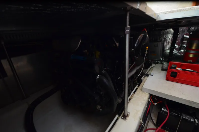 Slide: The Image of Engine room of a 2001 Carver 406 yacht, featuring mechanical components and storage. - 35