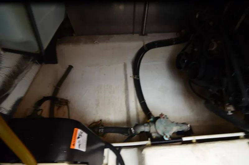 Slide: The Image of Engine compartment of a 2001 Carver 406 boat, showing hoses and mechanical components. - 38