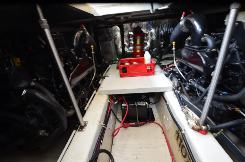 Slide: The Image of Engine room of a 2001 Carver 406 yacht, featuring dual engines and maintenance tools. - 39
