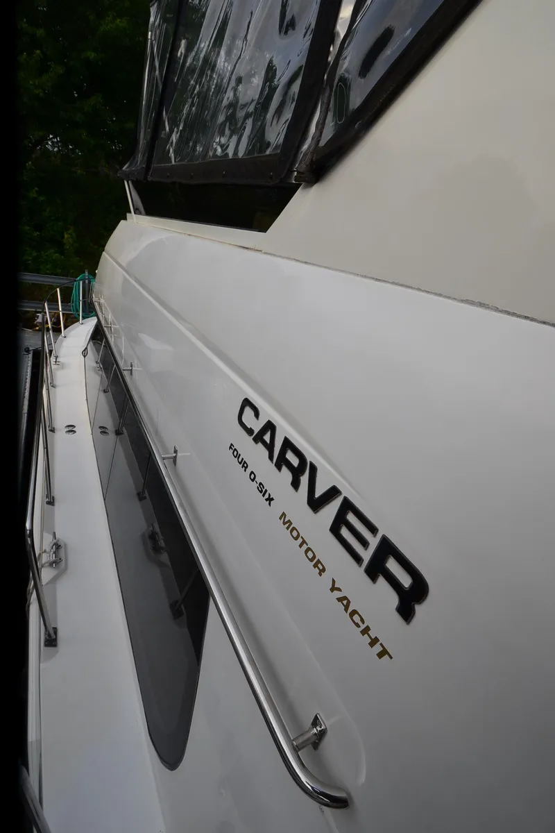 Slide: The Image of 2001 Carver 406 motor yacht, side view with logo and sleek design. - 45