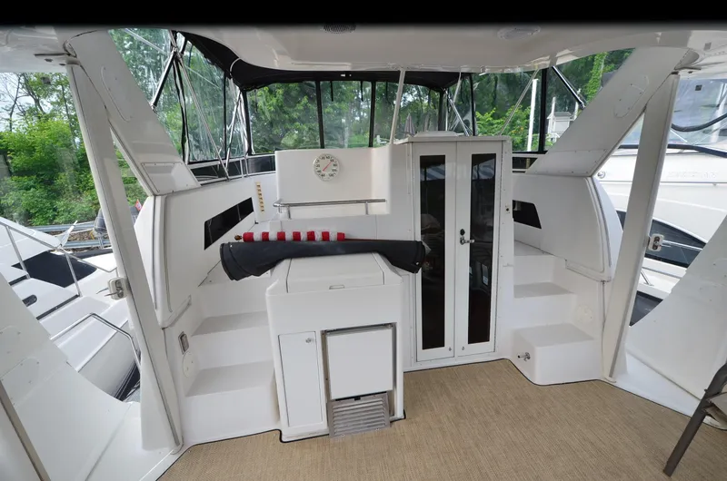 Slide: The Image of 2001 Carver 406 yacht interior with seating, storage, and windows. - 5