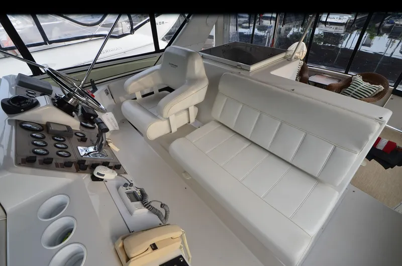 Slide: The Image of Interior of 2001 Carver 406 yacht with white leather seating and control panel. - 8