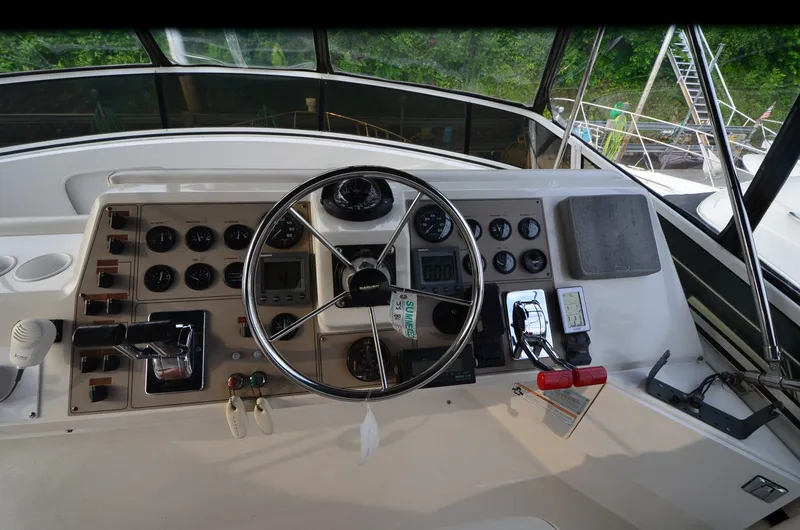 Slide: The Image of Control panel of a 2001 Carver 406 yacht with steering wheel and gauges. - 9