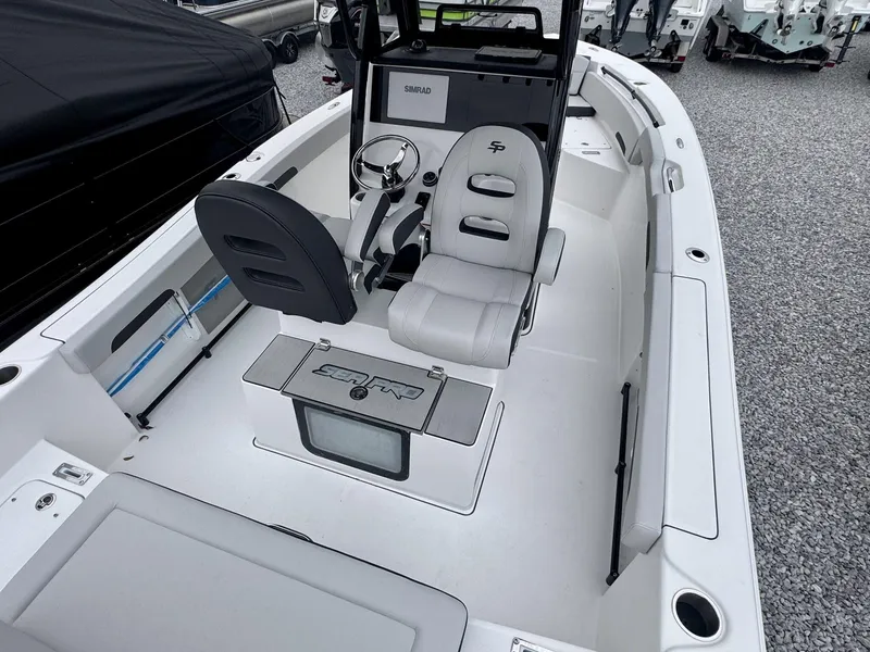 Slide: The Image of 2025 Sea Pro 245 SANDBAR boat interior with seating and steering console. - 3