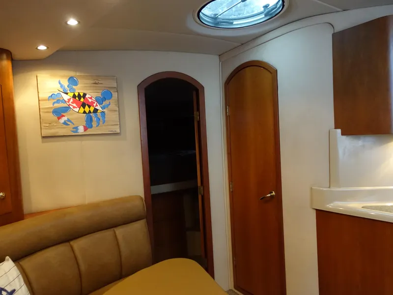 Slide: The Image of Interior of 2001 Cruisers Yachts 4270 Express with modern decor and colorful crab artwork. - 18