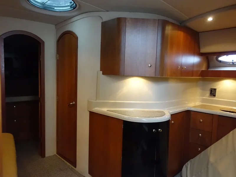 Slide: The Image of Interior of 2001 Cruisers Yachts 4270 Express with wood cabinets and modern lighting. - 19