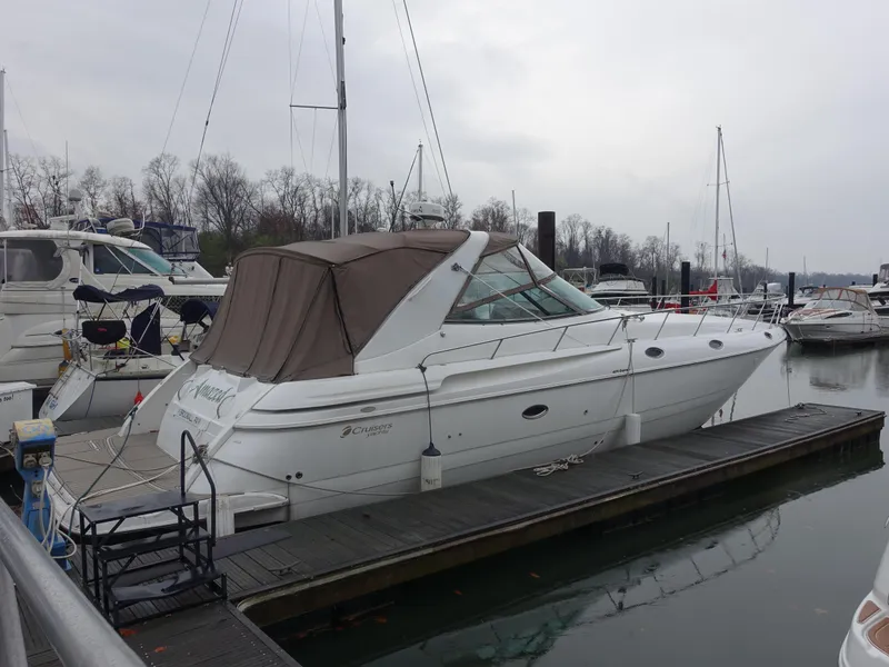 Slide: The Image of 2001 Cruisers Yachts 4270 Express docked at marina on a cloudy day. - 2