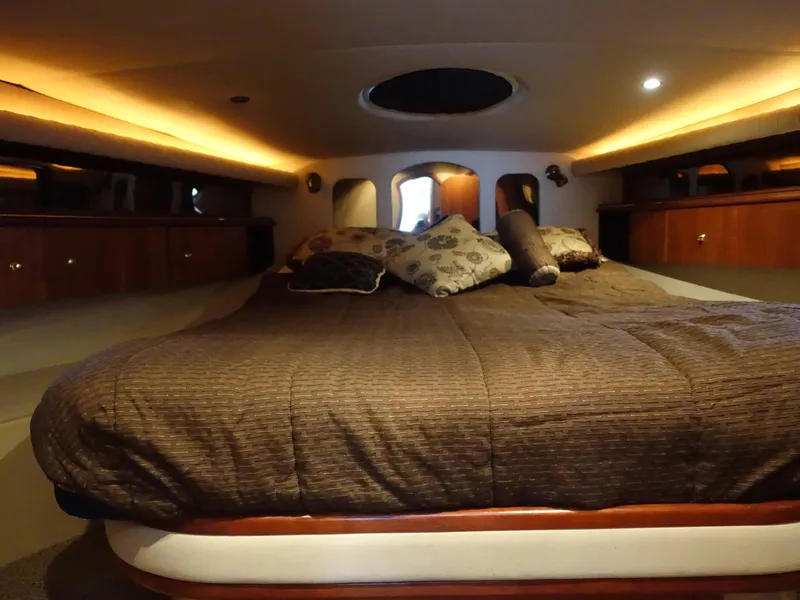 Slide: The Image of Luxurious cabin interior of 2001 Cruisers Yachts 4270 Express with cozy bedding. - 20