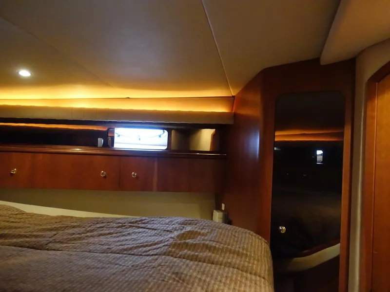 Slide: The Image of Interior cabin of 2001 Cruisers Yachts 4270 Express with cozy lighting and wood finish. - 21
