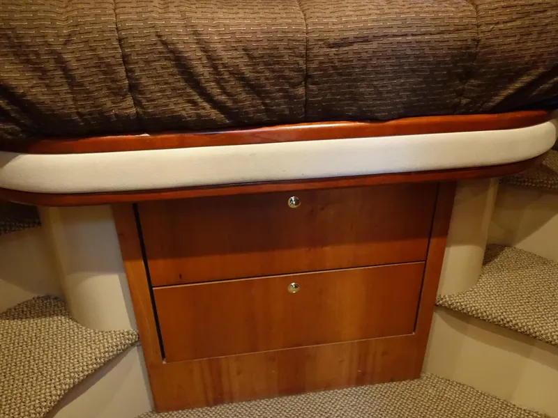 Slide: The Image of 2001 Cruisers Yachts 4270 Express cabin with wooden drawers and carpeted steps. - 22