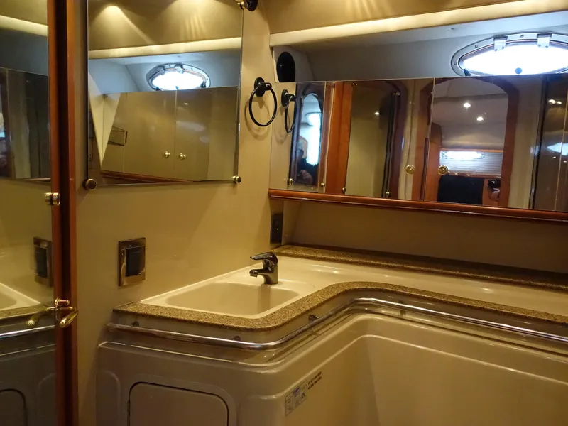 Slide: The Image of Luxurious bathroom interior of 2001 Cruisers Yachts 4270 Express with mirrored cabinets. - 23