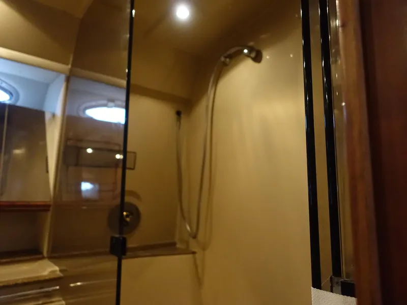 Slide: The Image of Shower area in 2001 Cruisers Yachts 4270 Express, featuring modern fixtures and lighting. - 24