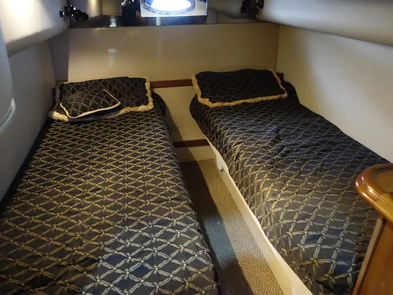 Slide: The Image of Twin beds in 2001 Cruisers Yachts 4270 Express cabin, featuring patterned bedding. - 33