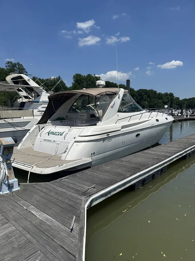 Slide: The Image of 2001 Cruisers Yachts 4270 Express docked at marina under clear blue sky. - 38