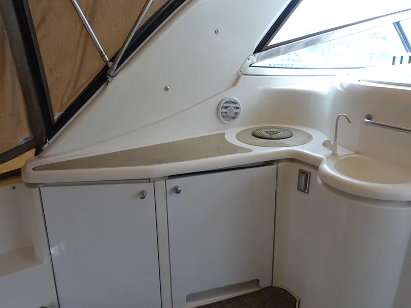 Slide: The Image of 2001 Cruisers Yachts 4270 Express interior with sink and storage cabinets. - 4