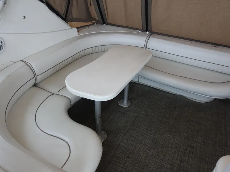 Slide: The Image of 2001 Cruisers Yachts 4270 Express interior with white leather seating and table. - 5