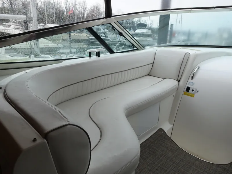 Slide: The Image of 2001 Cruisers Yachts 4270 Express interior with white leather seating and panoramic windows. - 6