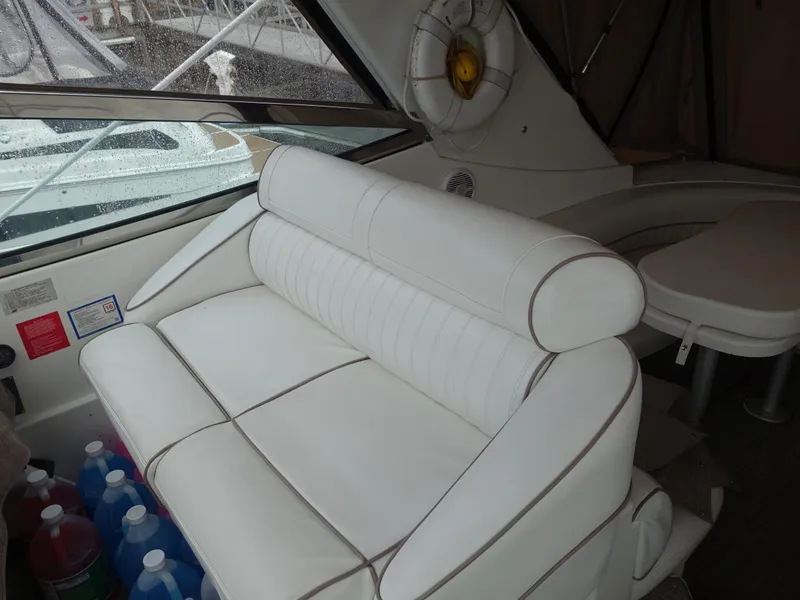 Slide: The Image of 2001 Cruisers Yachts 4270 Express interior with white seating and life preserver. - 7