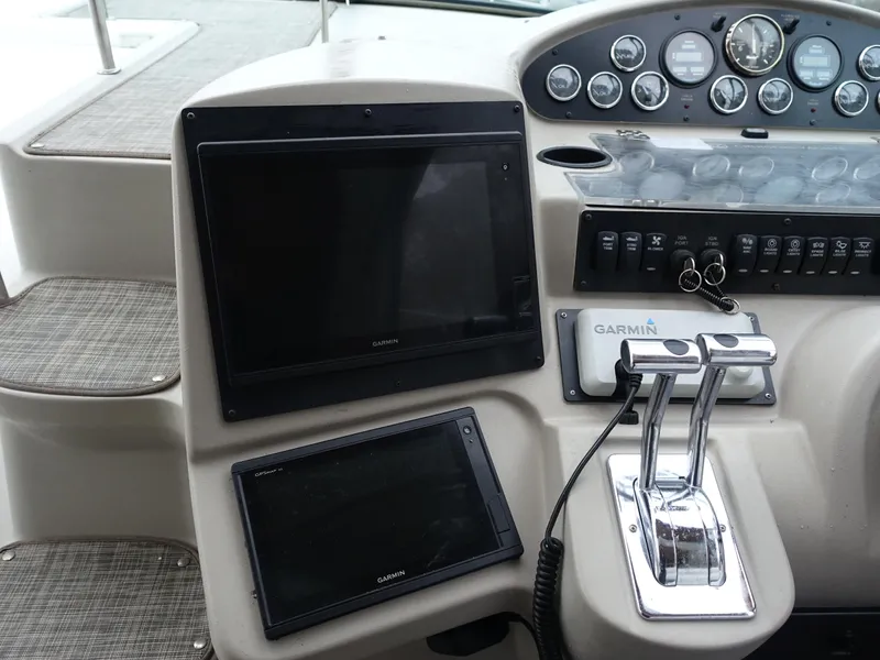 Slide: The Image of 2001 Cruisers Yachts 4270 Express helm with Garmin navigation and control panel. - 8