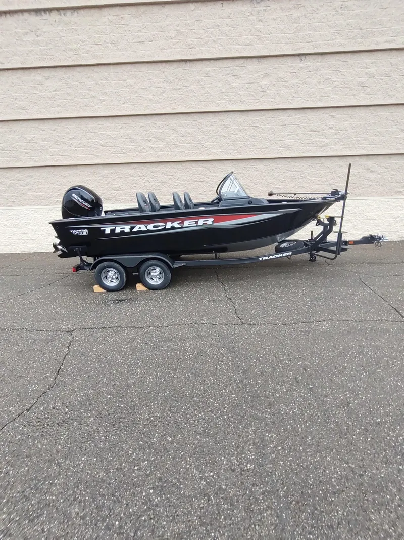 Slide: The Image of 2025 Tracker Targa V-18 Combo boat on trailer, parked outdoors. - 3