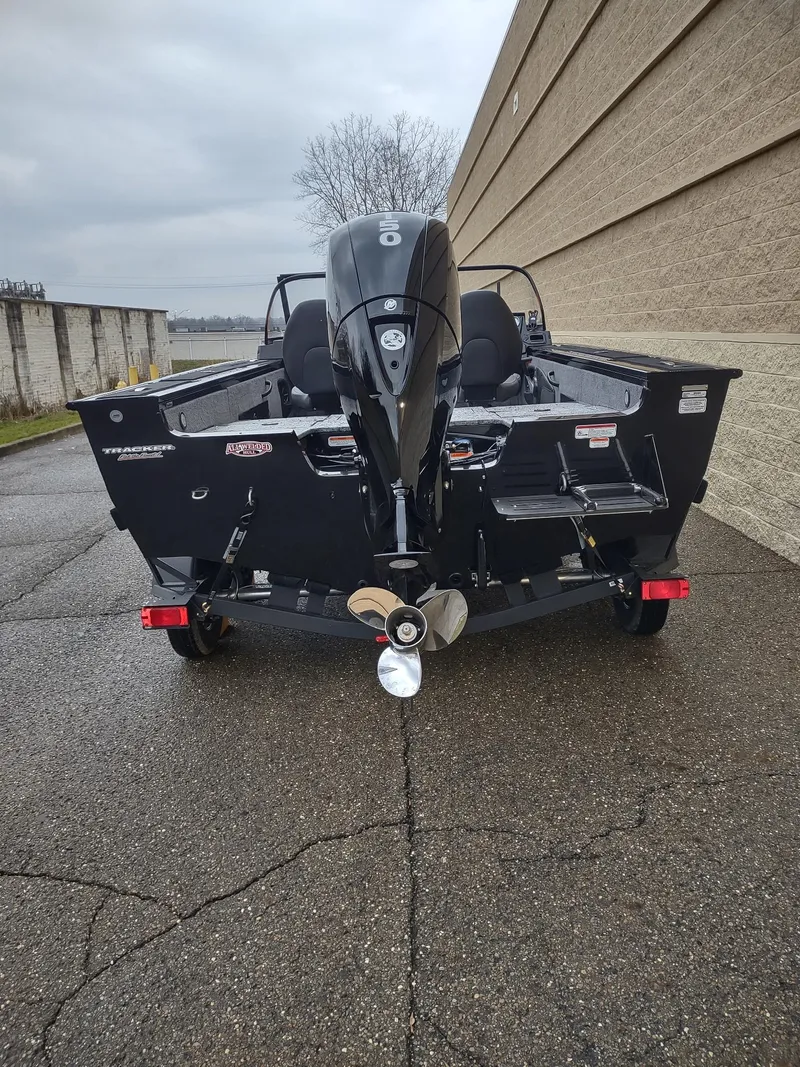 Slide: The Image of 2025 Tracker Targa V-18 Combo boat, rear view, parked on pavement. - 5