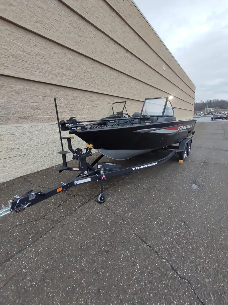 Slide: The Image of 2025 Tracker Targa V-18 Combo boat on trailer, parked outdoors. - 7