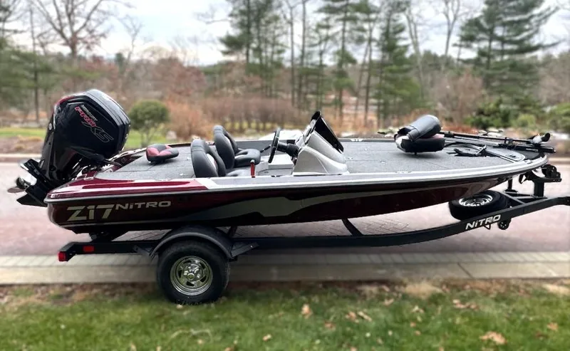 Slide: The Image of 2025 Nitro Z17 boat on trailer, parked outdoors, side view. - 1