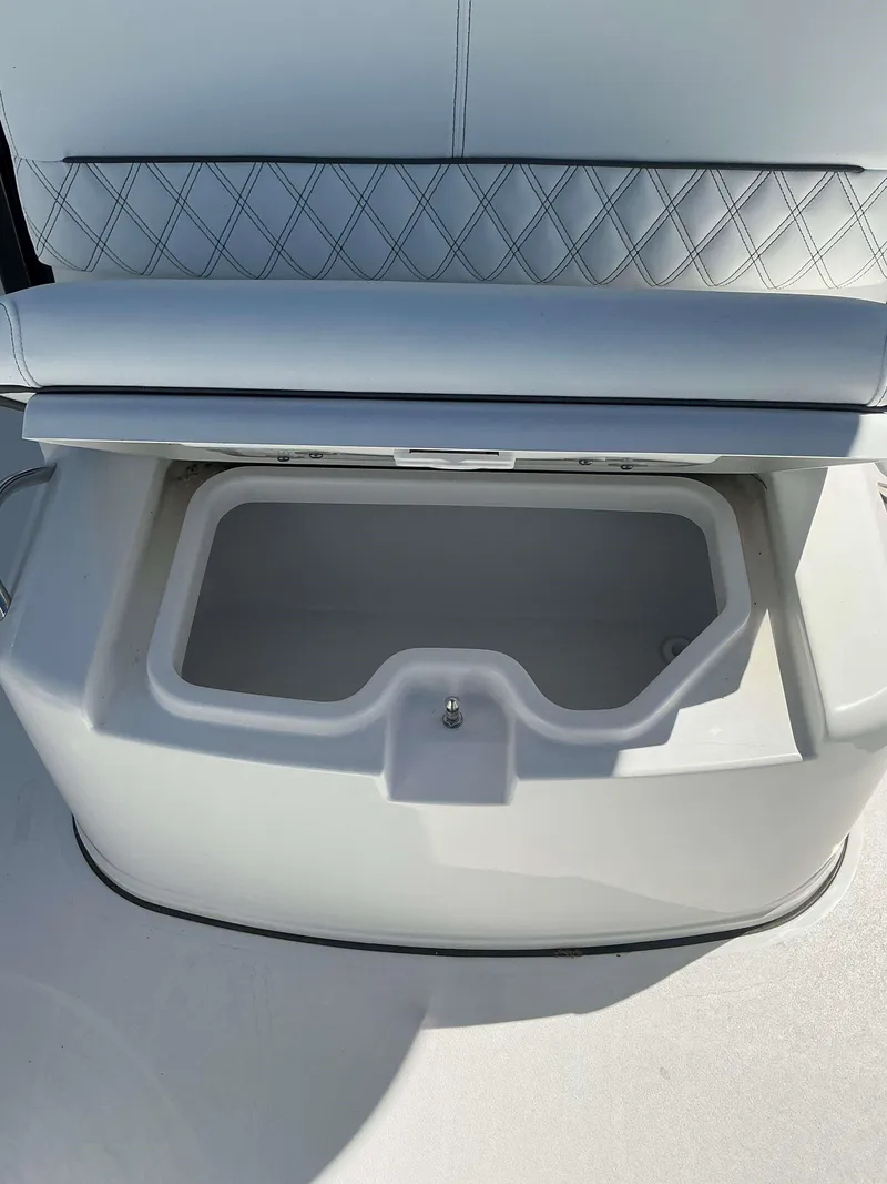 Slide: The Image of Open storage compartment on 2025 Sportsman 261 Heritage boat with cushioned seat. - 16