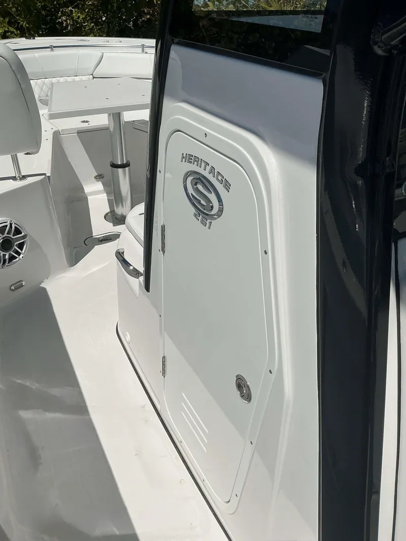 Slide: The Image of 2025 Sportsman 261 Heritage boat interior with seating and storage compartment. - 20