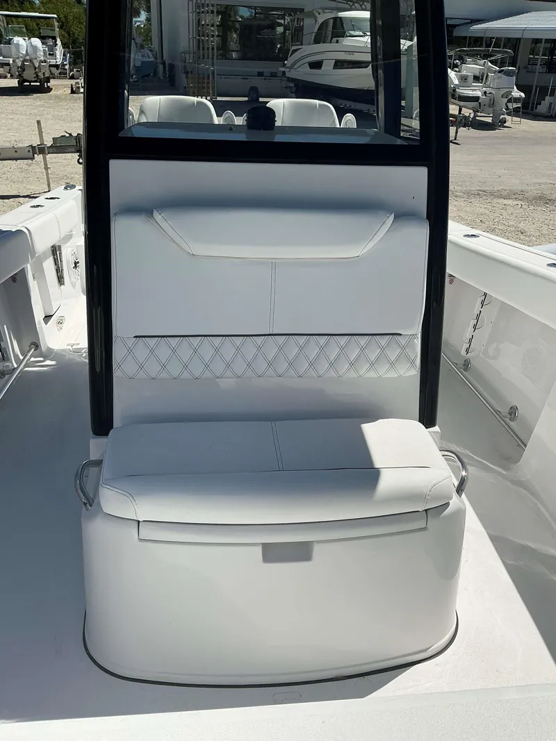 Slide: The Image of 2025 Sportsman 261 Heritage boat interior with white seating and storage compartment. - 3