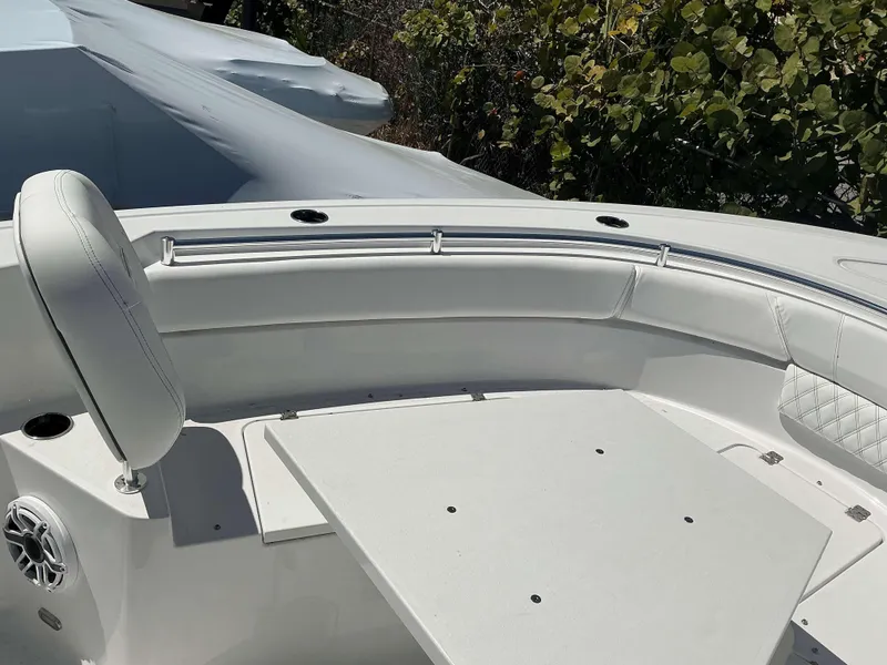 Slide: The Image of 2025 Sportsman 261 Heritage boat interior with cushioned seating and table. - 5