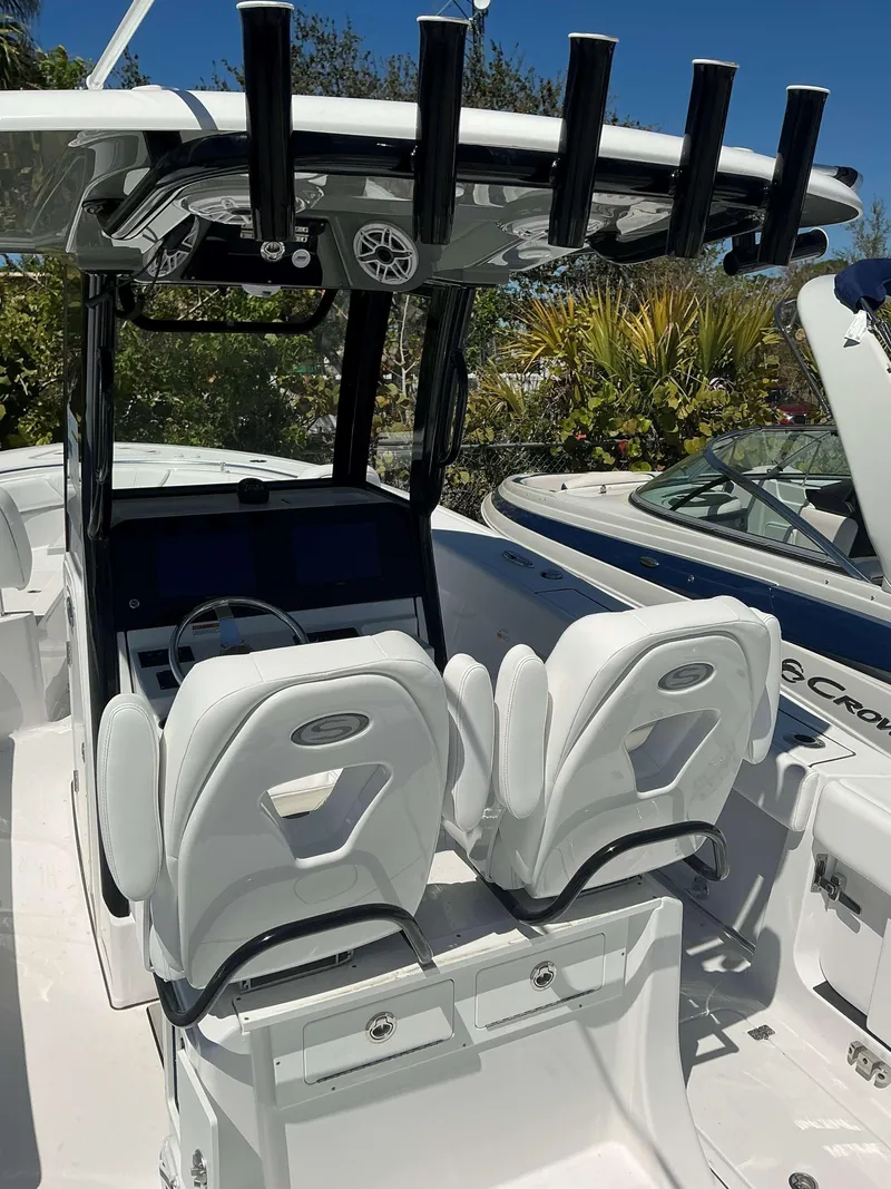 Slide: The Image of 2025 Sportsman 261 Heritage boat interior with dual white seats and rod holders. - 8