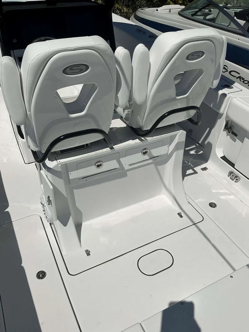 Slide: The Image of 2025 Sportsman 261 Heritage boat interior with white cushioned seats and storage compartments. - 9