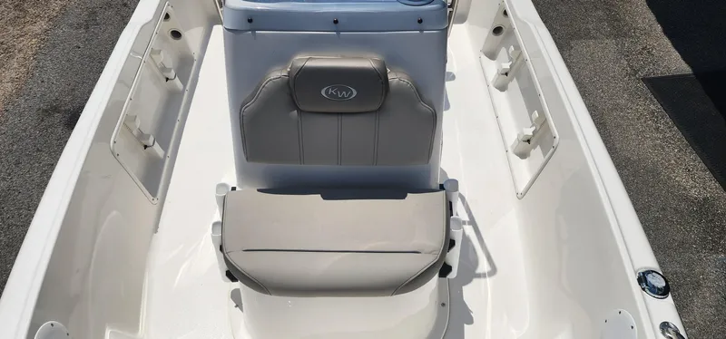 Slide: The Image of 2024 Key West 1720CC boat interior with cushioned seating and storage compartments. - 12