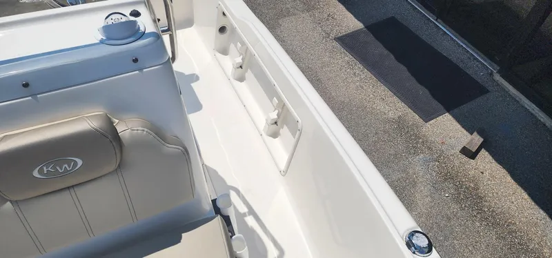 Slide: The Image of 2024 Key West 1720CC boat interior with beige seating and console details. - 15